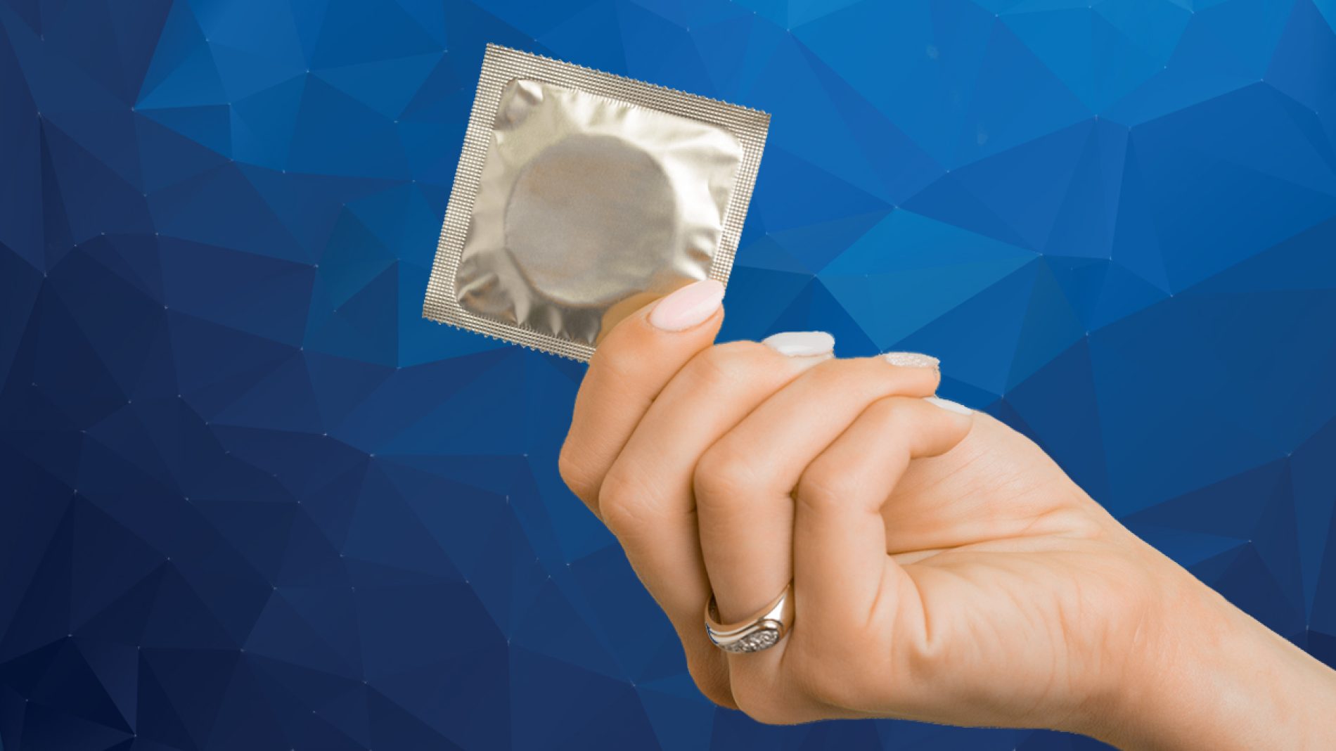 A hand holding a condom.
