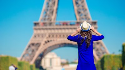 Beautiful woman in Paris background the Eiffel tower during summer vacation