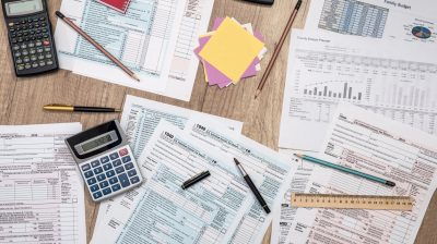 saving concept - tax form, budget, notepad, pen, calculator