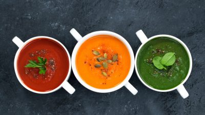 assortment of fresh vegetable soup on a dark background
