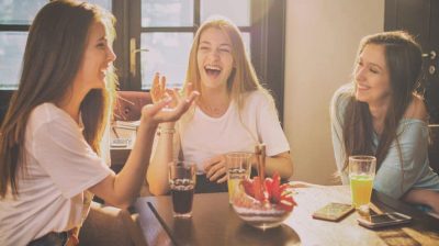 Three_women_chatting_at_table