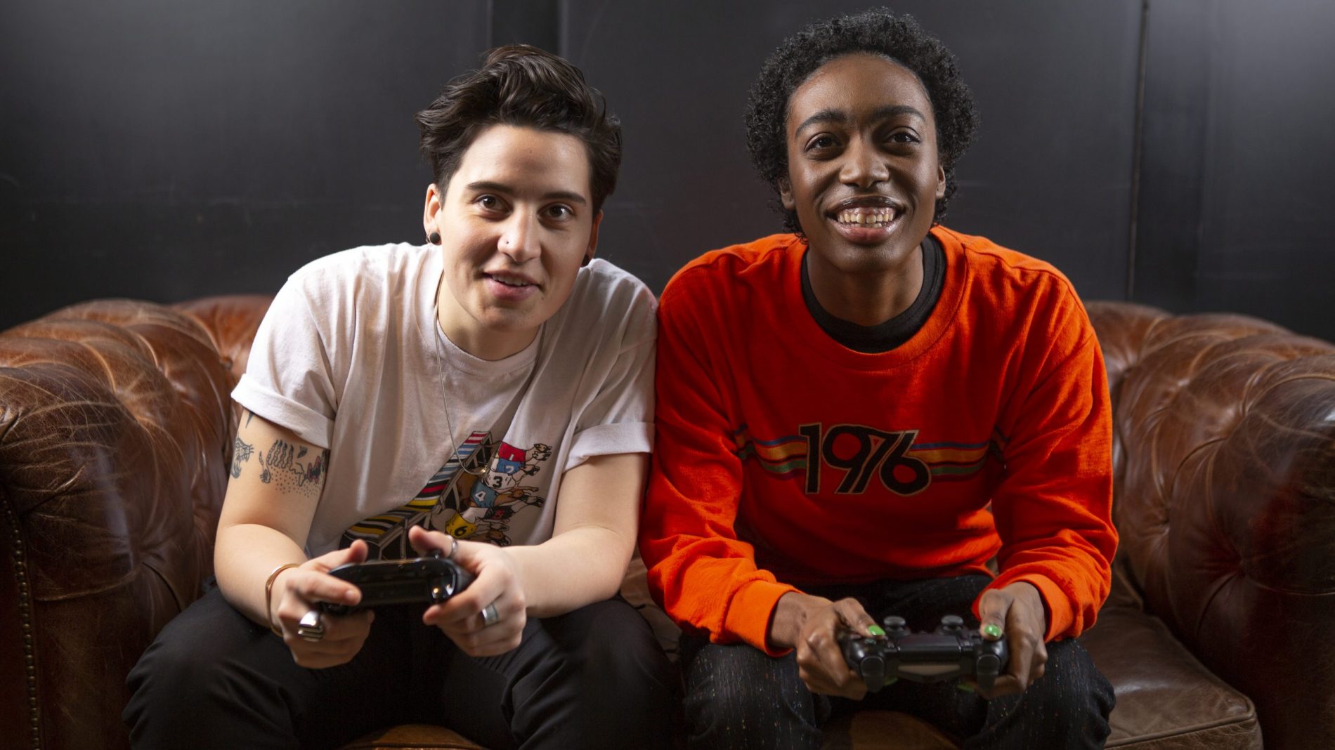 Two non binary friends playing video games together