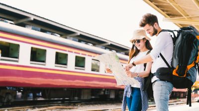 Two people in a train station looking at a map