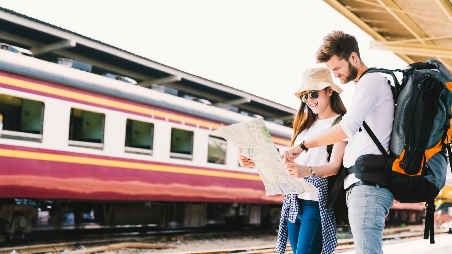 Two people in a train station looking at a map