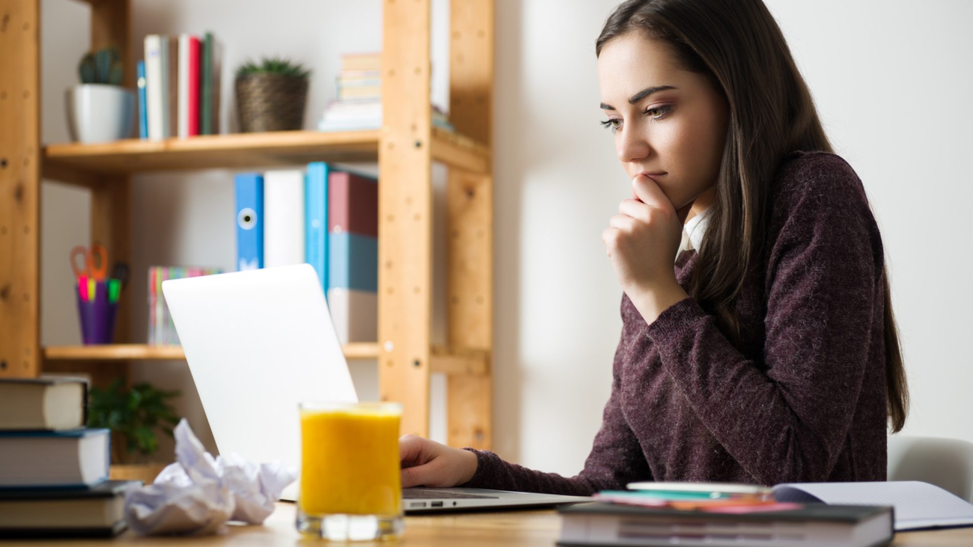 Attractive caucasian girl studying for her exams at home