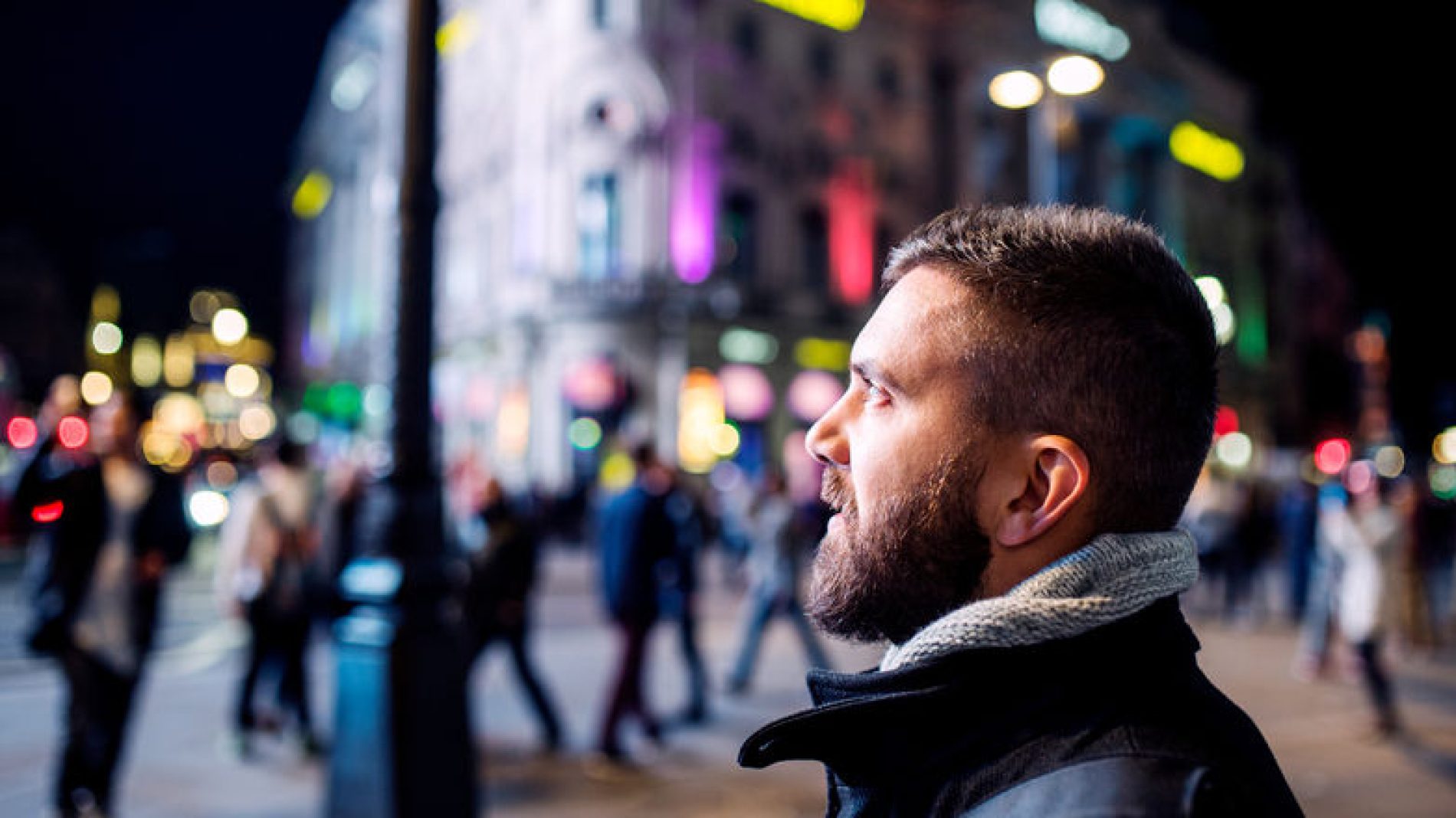 Young-man-looking-at-street-lights