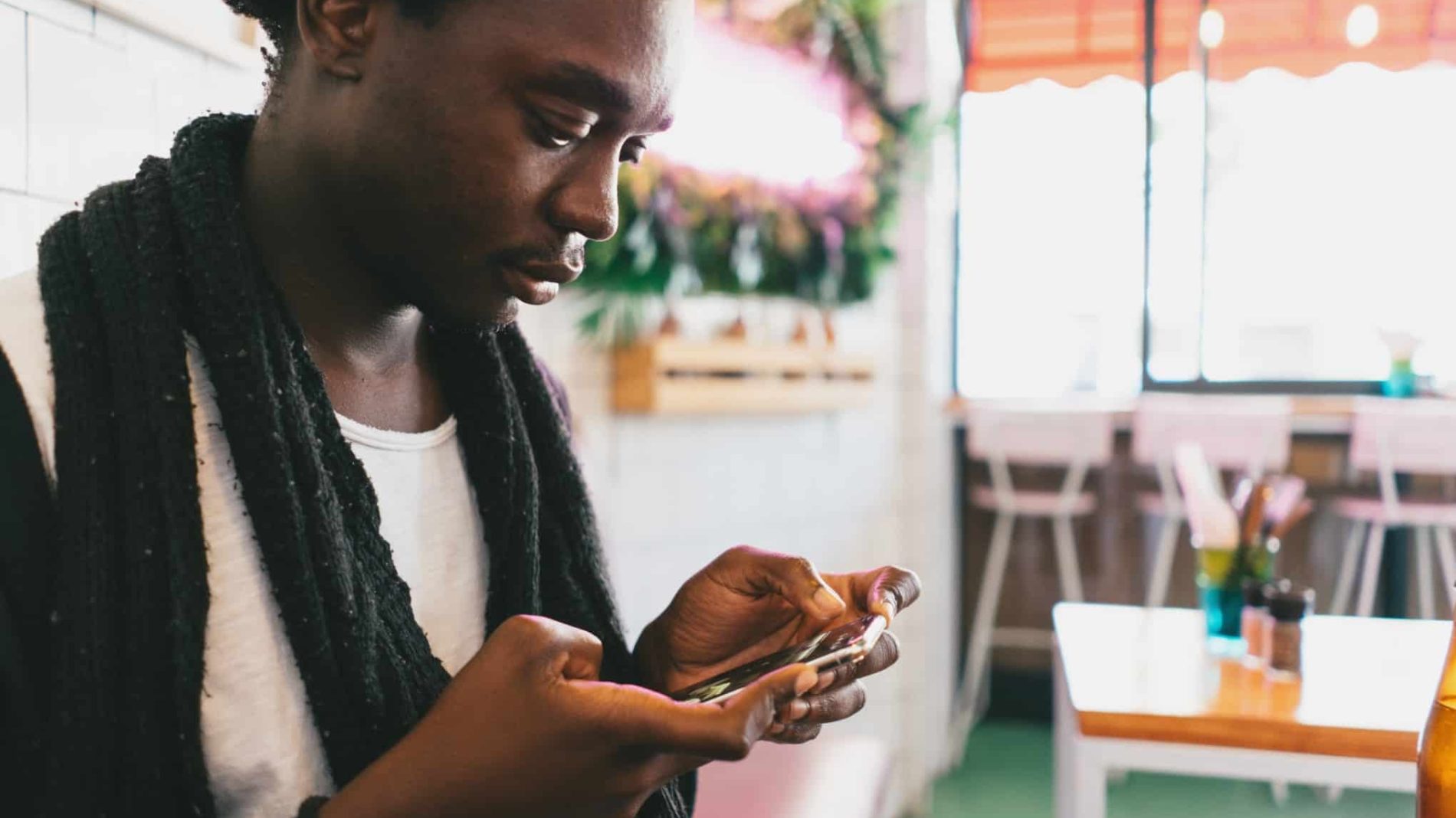 Young man deleting social media from their phone