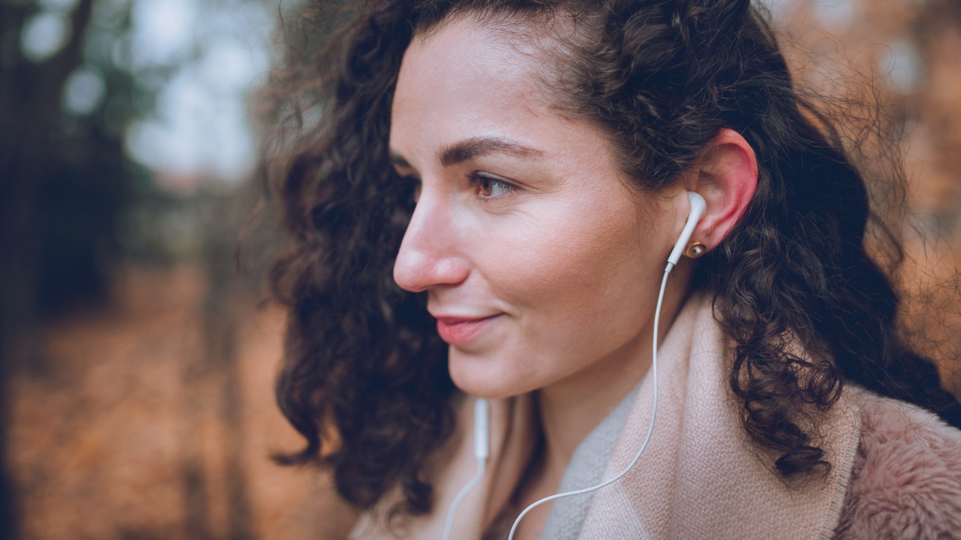 Young person practising self-care and listening to music