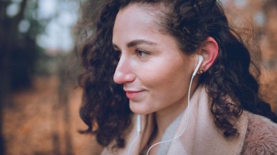 Young person practising self-care and listening to music