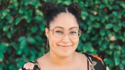 Young-person-smiling-at-the-camera-with-glasses