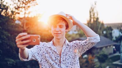 Young person taking a selfie in the sun