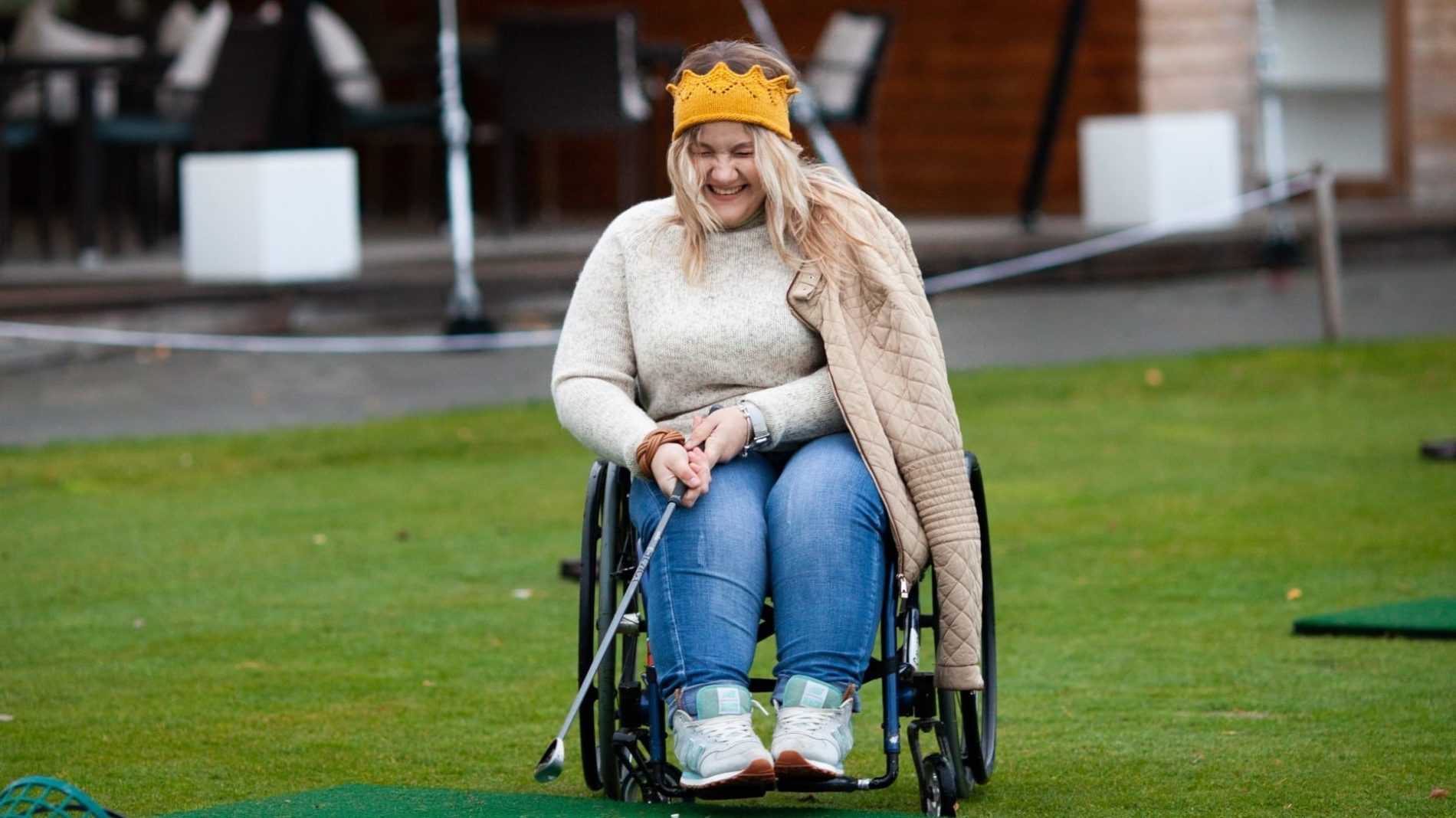 Young woman in a wheelchair playing golf
