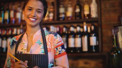 Portrait of waitress taking an order on notepad