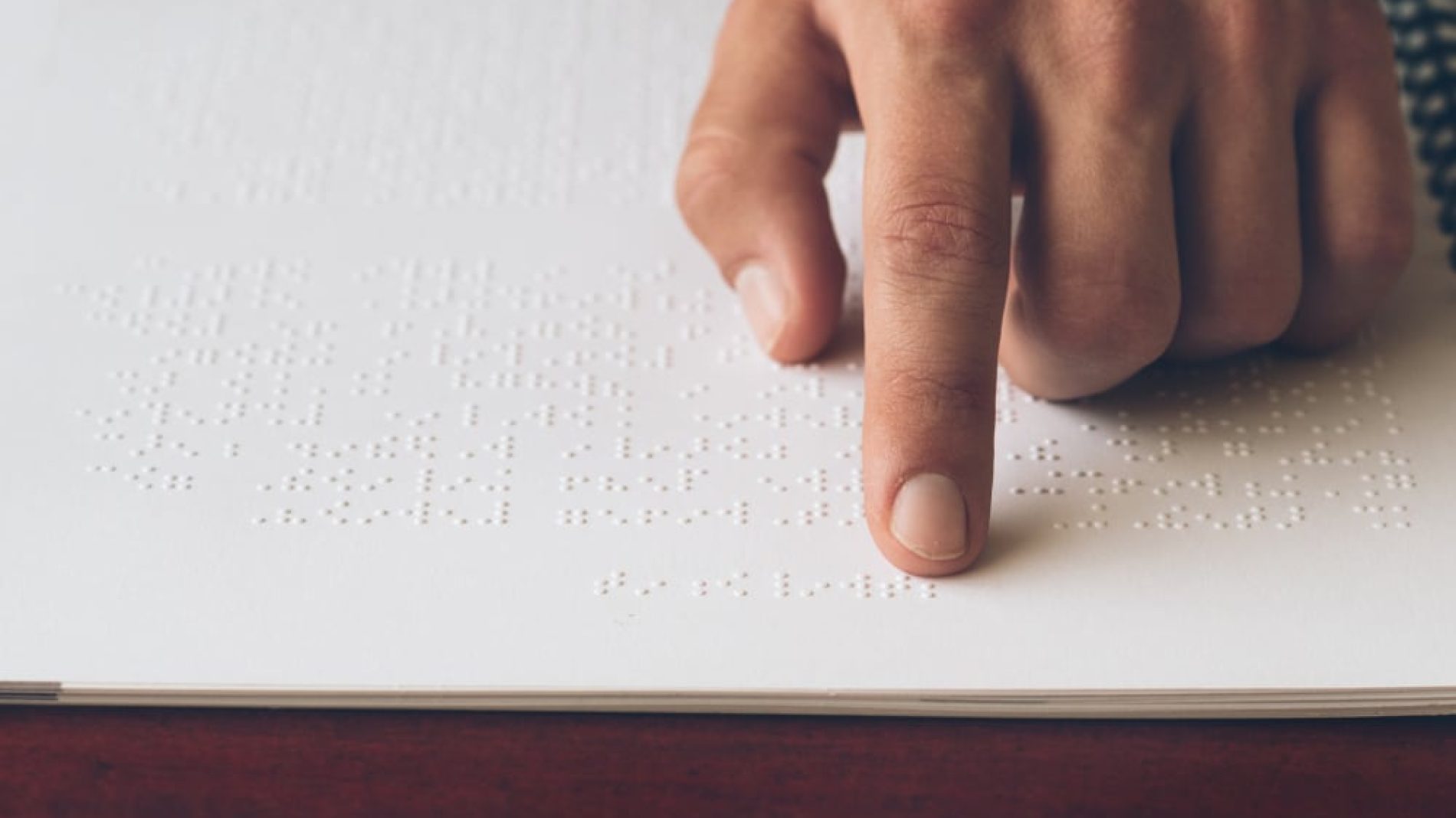 a person reading braille