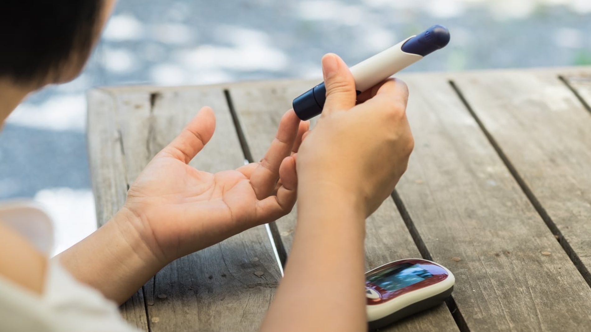 A woman is checking her blood sugars