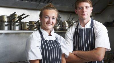 Portrait Of Chef And Trainee In Kitchen