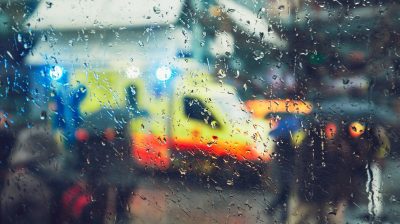 A photo of an ambulance through a rainy window
