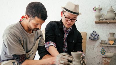 Photo of two people in a pottery class