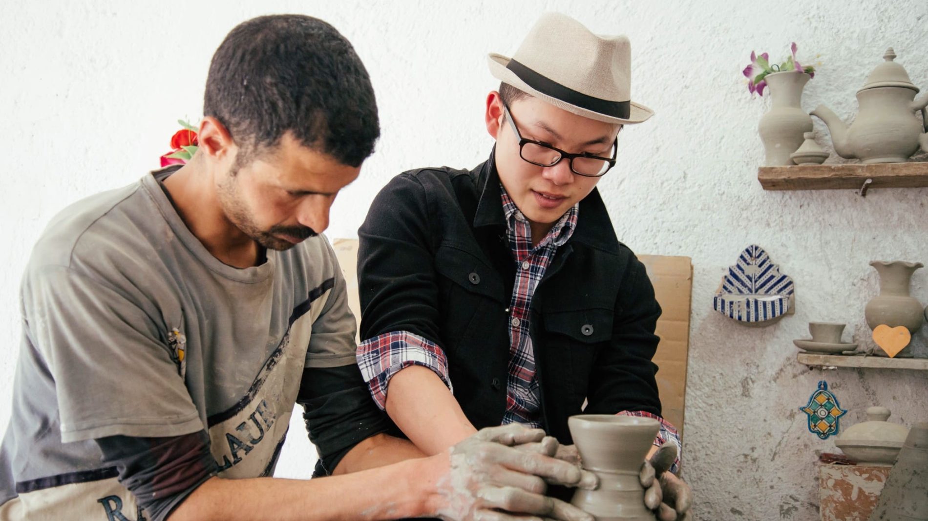 Photo of two people in a pottery class