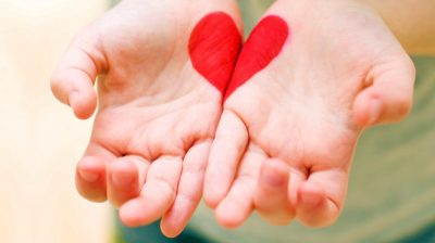 hands held palm up and open, they join together to form a heart | compassion