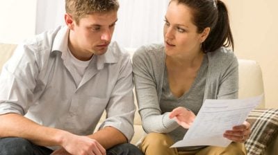 Worried couple talking about their expenses and financial problems