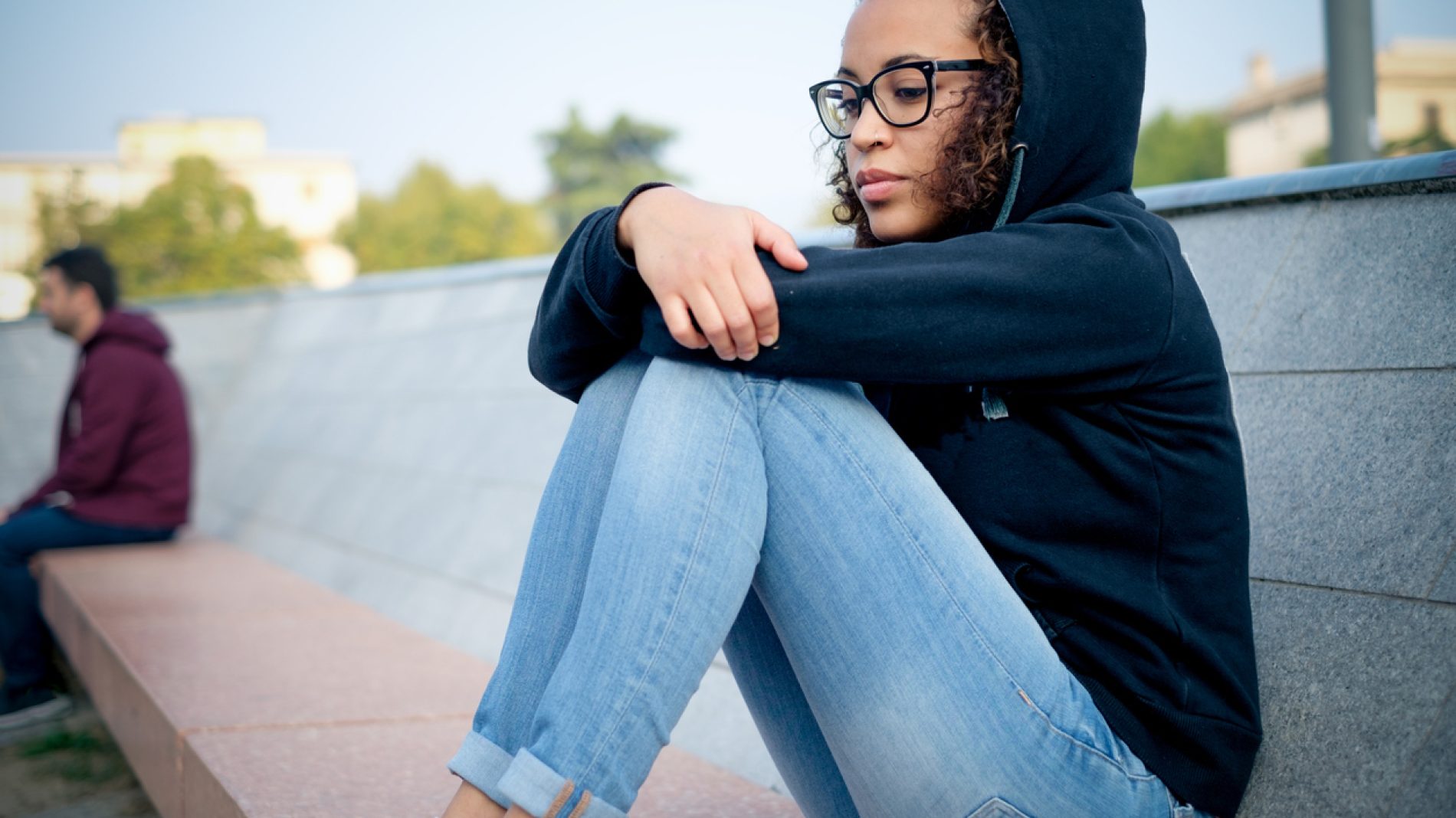 Sad young afro-american girl alone in the city street