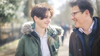 A son talks to his dad on a walk