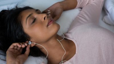 Woman sleeping while listening to music