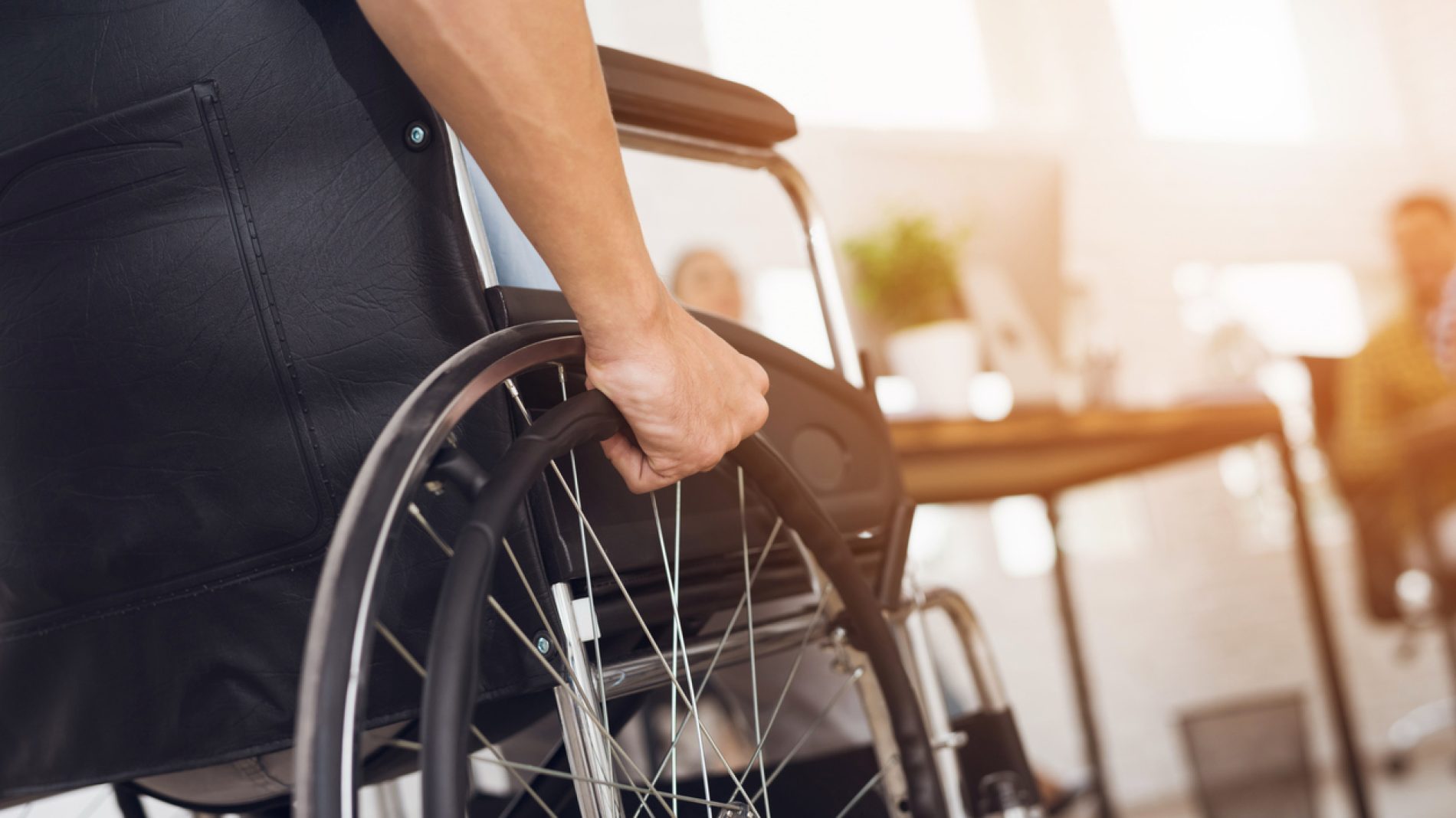 A disabled man is sitting in a wheelchair.
