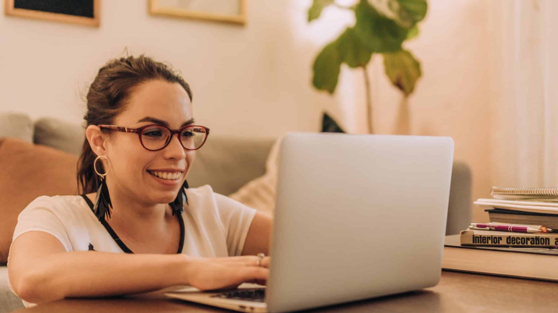 Photo of a person smiling while using their laptop