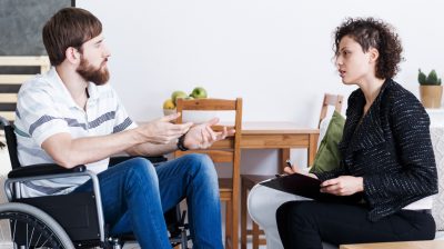 Young man talking with therapist