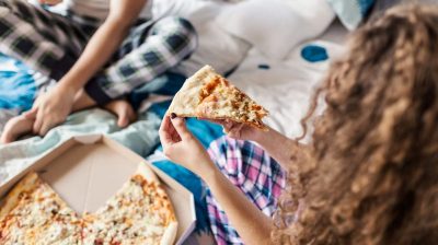 Young people eating pizza
