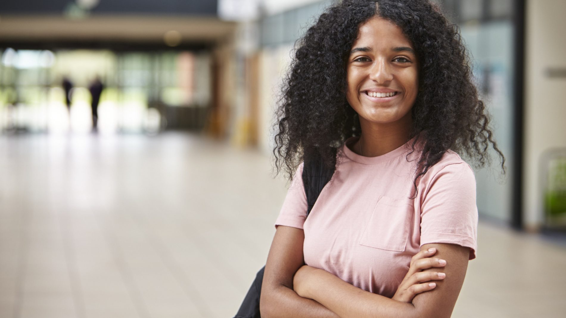 Portrait Of Female Student Standing In College Building
