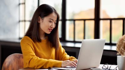 Young woman on a laptop in a cafe