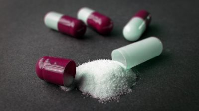 A capsule with powder spilling out of it