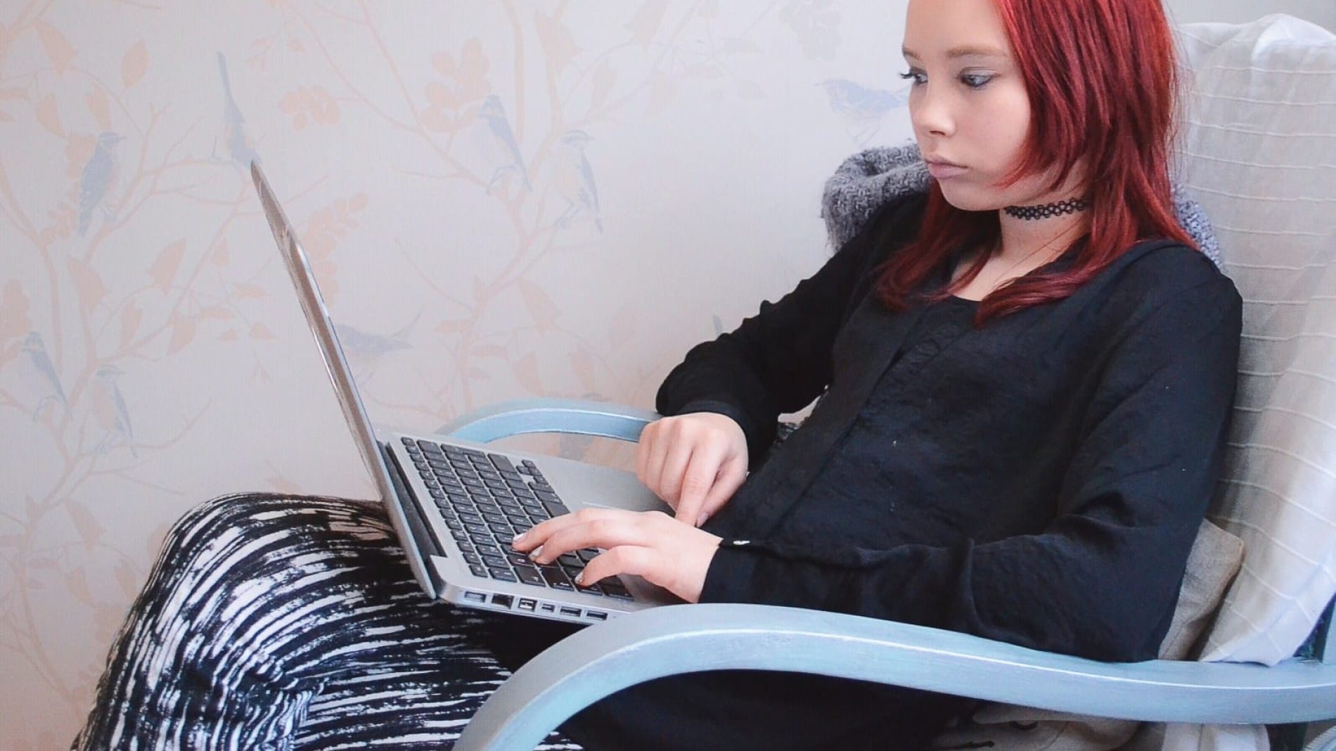 Photo of a young person using their laptop