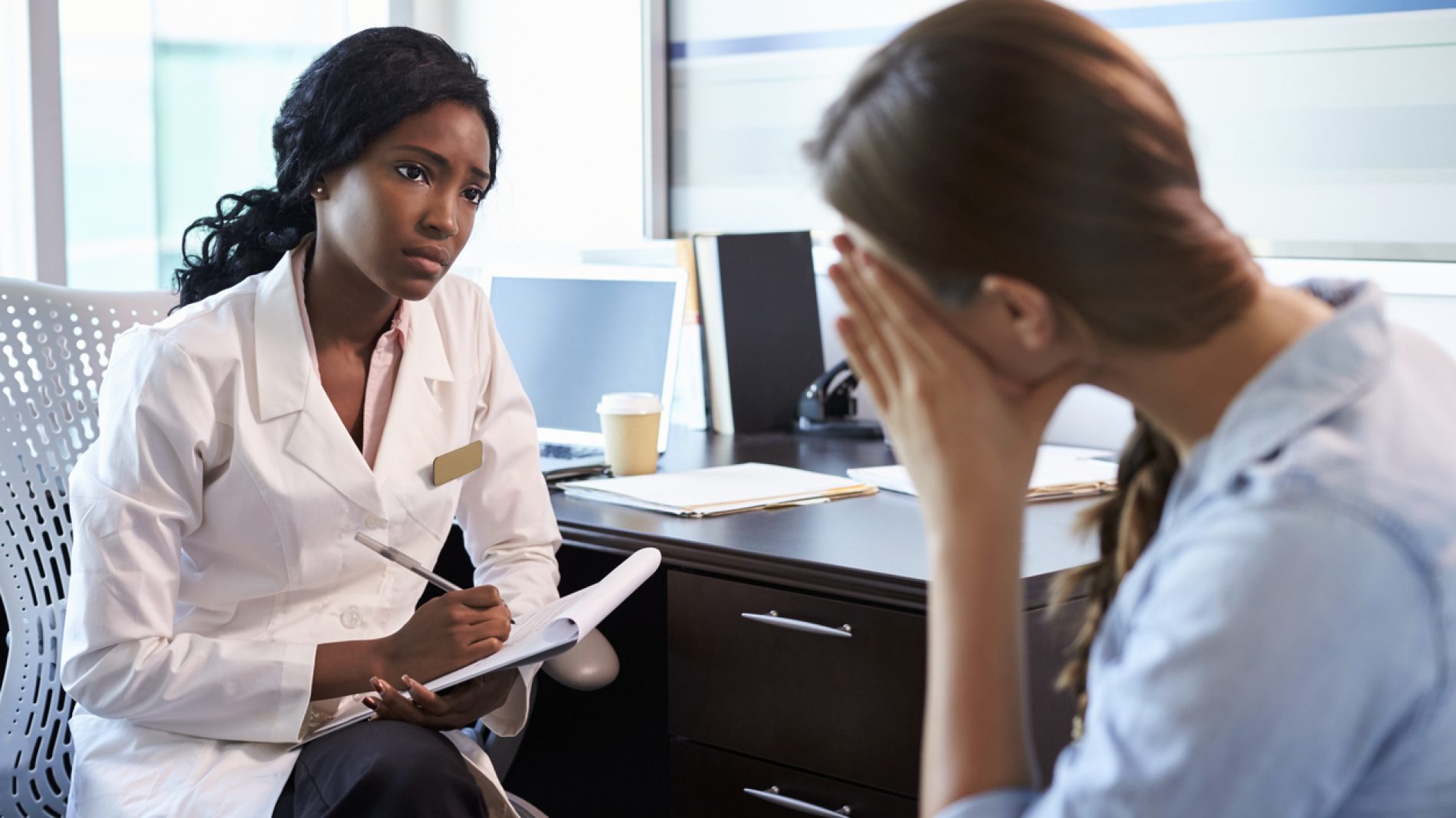 Doctor In Consultation With Depressed Female Patient
