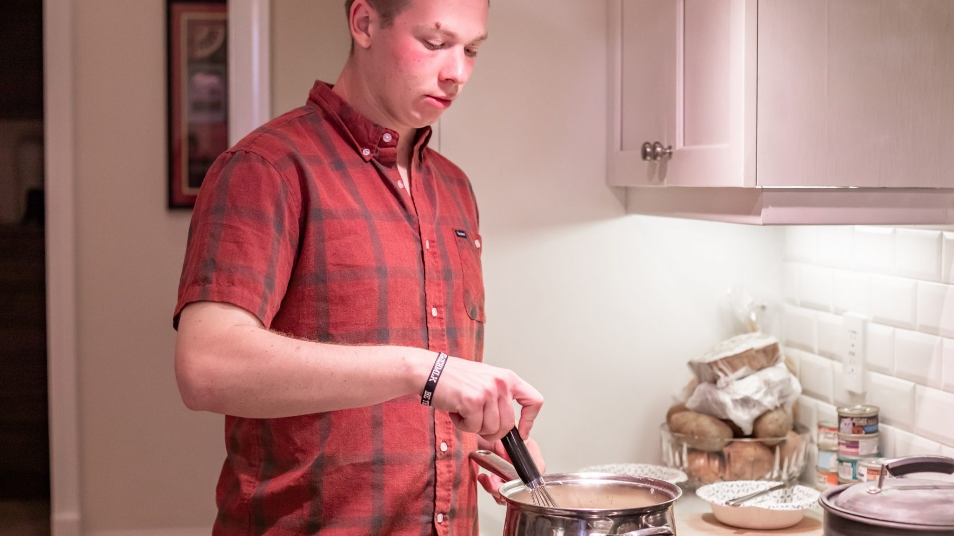 thanksgiving-in-the-kitchen-making-dinner-man-stirring-pot-at-the-stove_t20_yX0xL9