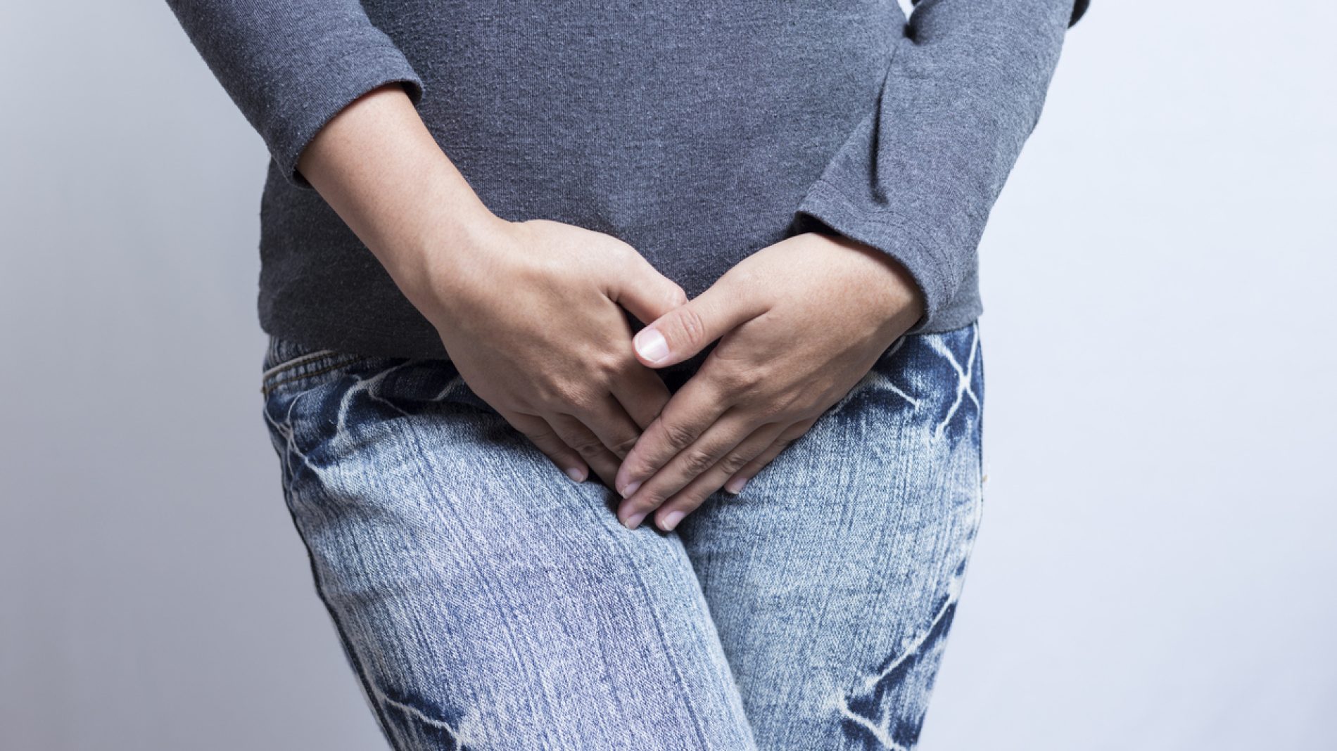 Woman with Hands Holding her Crotch