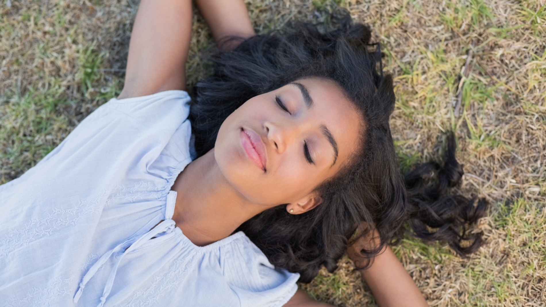 A young woman sleeping on the ground