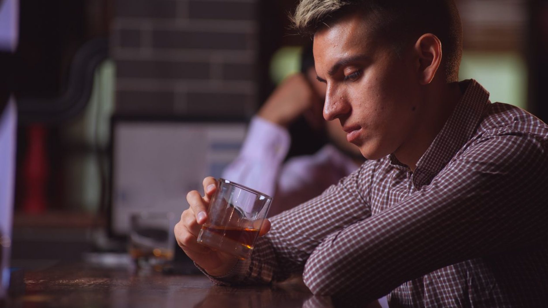 young-man-looking-at-drink