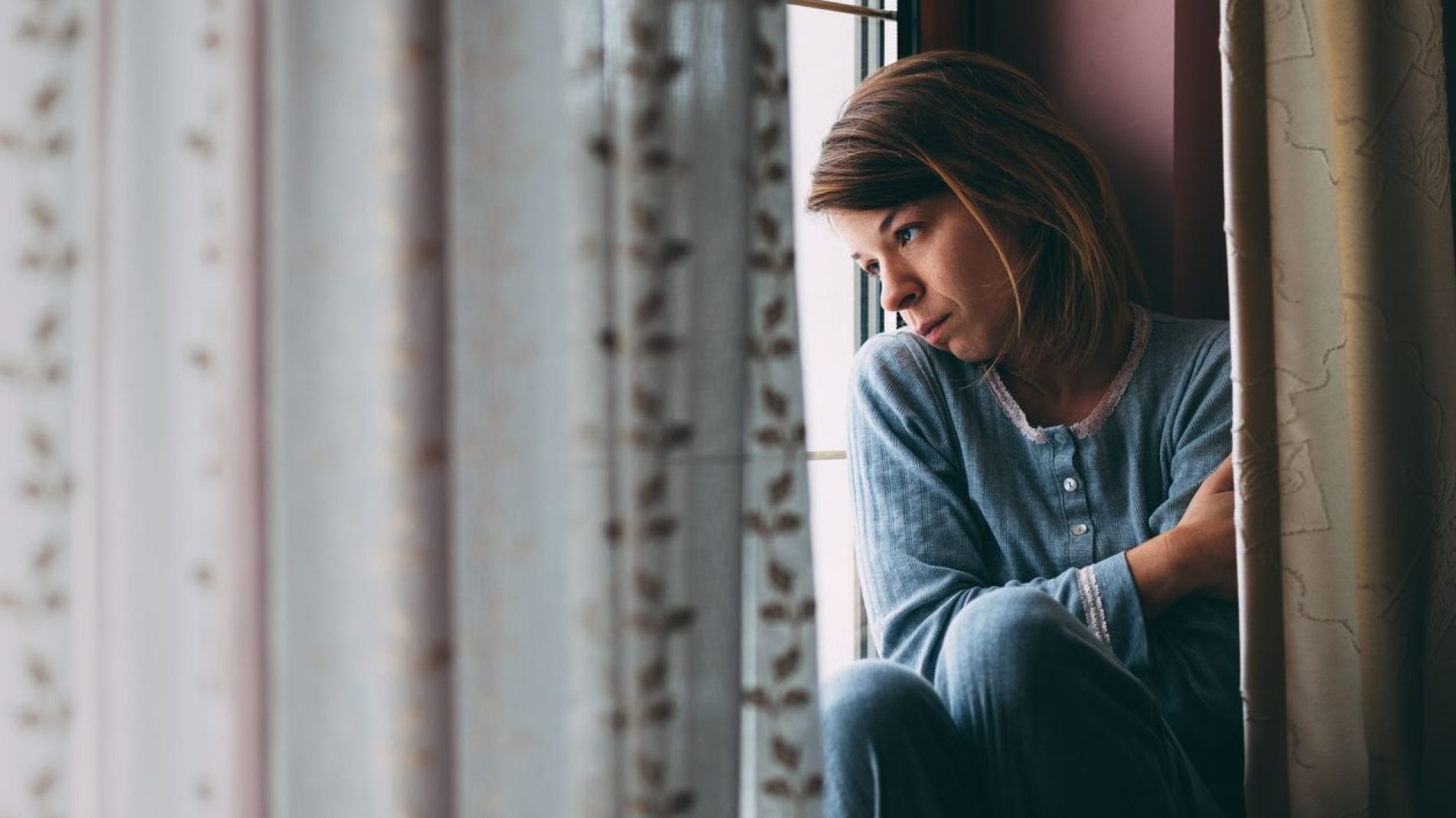 young-woman-looking-out-window